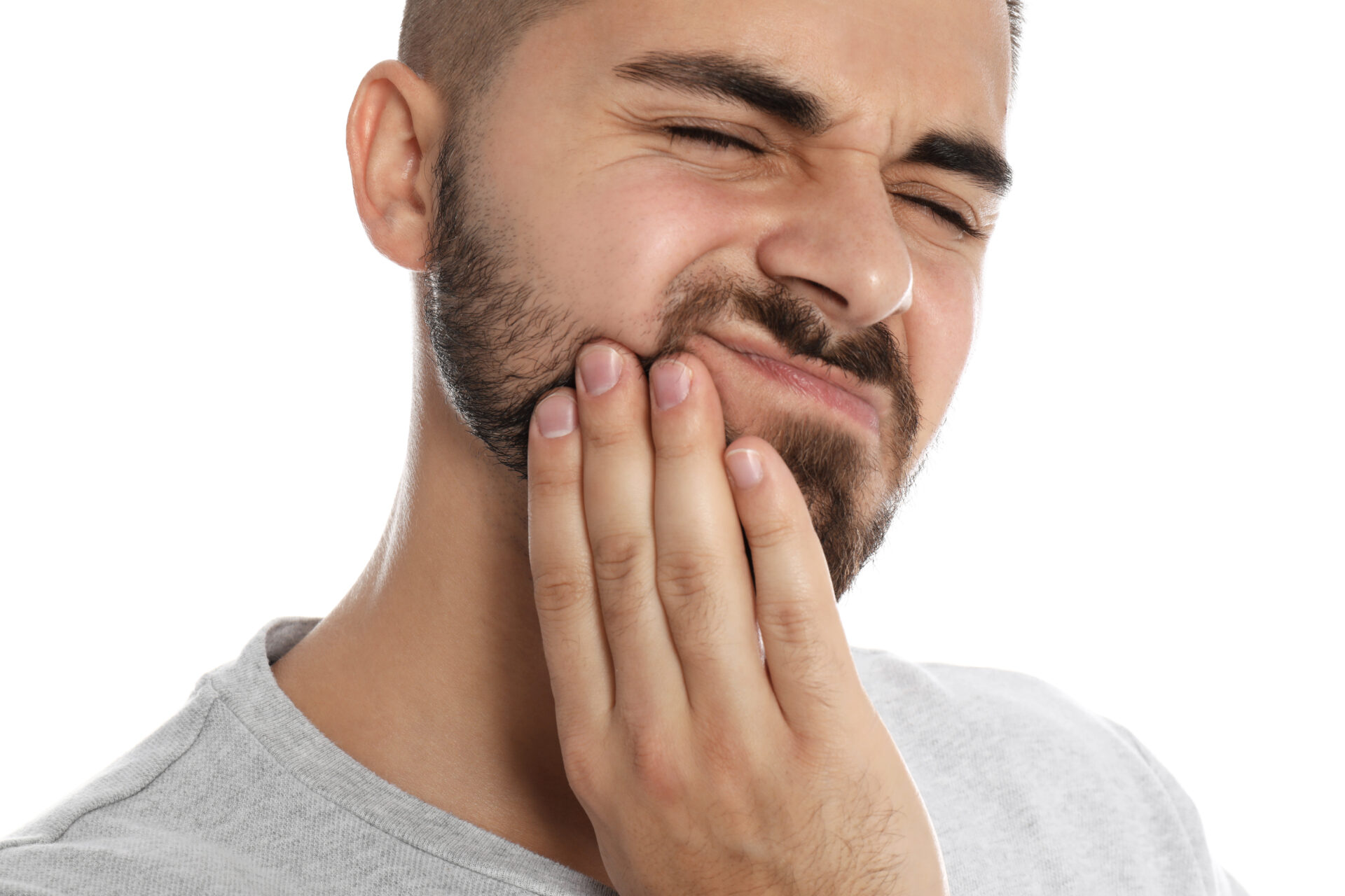 Man suffering from acute toothache on white background, closeup